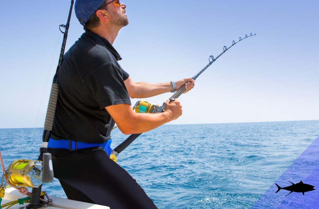 Tuna Fisherman Using Standup fishing gear fighting and reeling in a Tuna