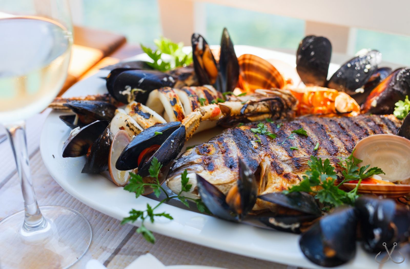 grilled bluefish with mussels on a plate